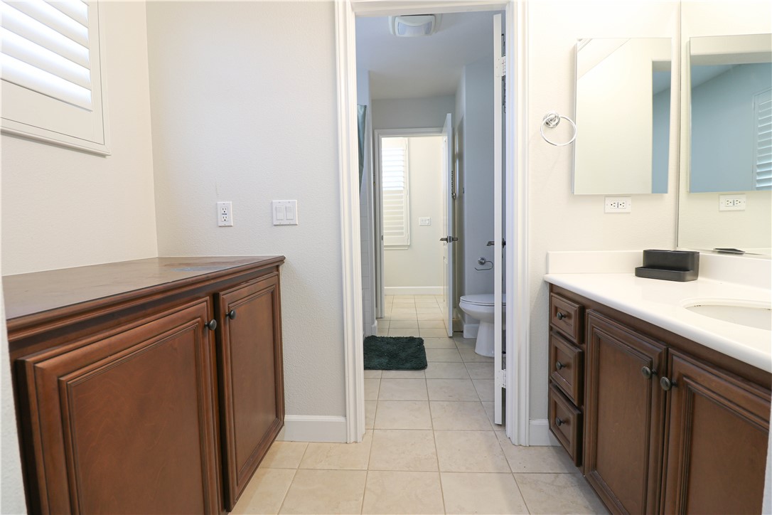 2850 North Stone Pine Glen Santa Ana, CA 92706 - Photo 19 of 45 a bathroom with a sink a toilet and shower