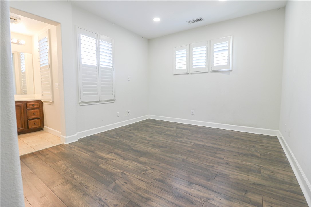 2850 North Stone Pine Glen Santa Ana, CA 92706 - Photo 23 of 45 an empty room with wooden floor and windows