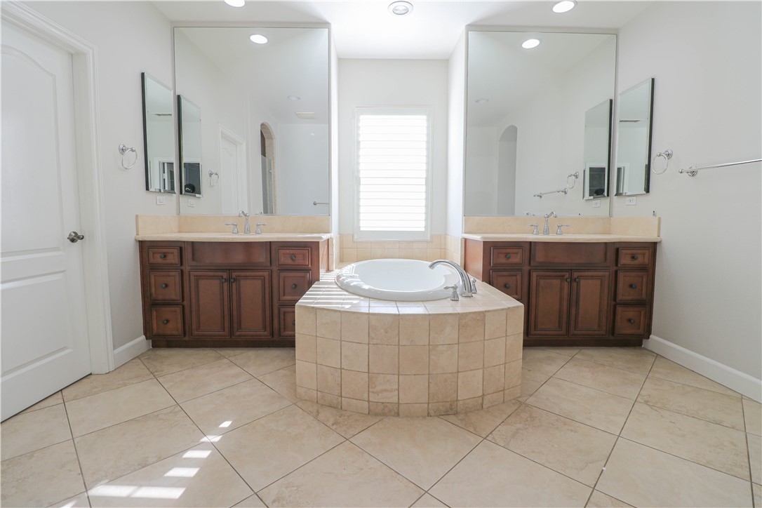 2850 North Stone Pine Glen Santa Ana, CA 92706 - Photo 25 of 45 a spacious bathroom with a tub sink and mirror