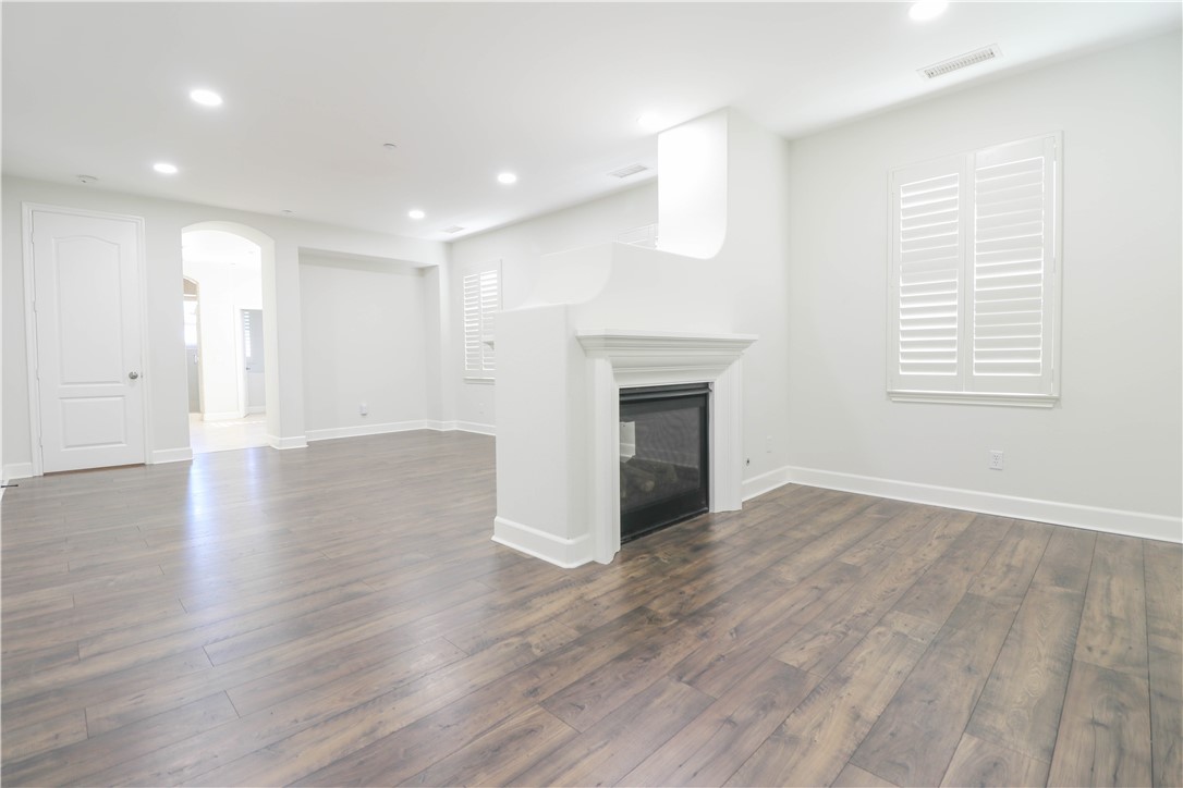2850 North Stone Pine Glen Santa Ana, CA 92706 - Photo 31 of 45 an empty room with wooden floor fireplace and windows