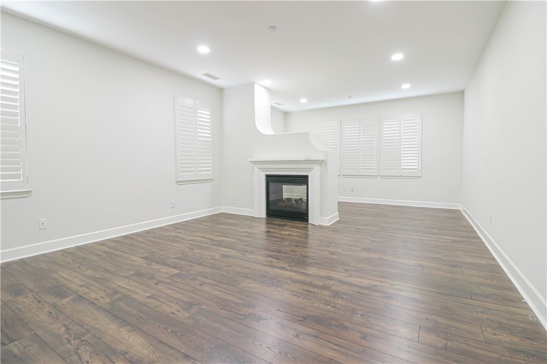 2850 North Stone Pine Glen Santa Ana, CA 92706 - Photo 33 of 45 an empty room with wooden floor a fireplace and a window