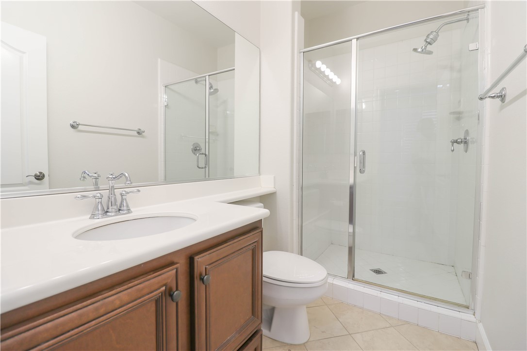 2850 North Stone Pine Glen Santa Ana, CA 92706 - Photo 34 of 45 a bathroom with a granite countertop sink a toilet and shower