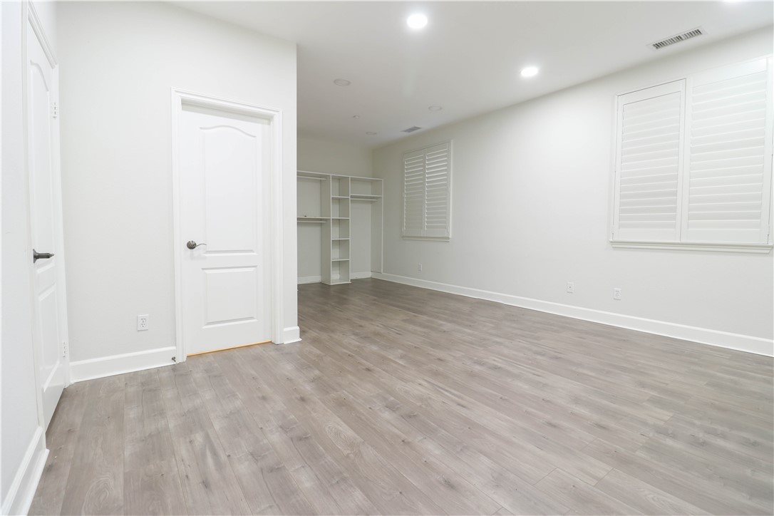 2850 North Stone Pine Glen Santa Ana, CA 92706 - Photo 35 of 45 an empty room with wooden floor and windows