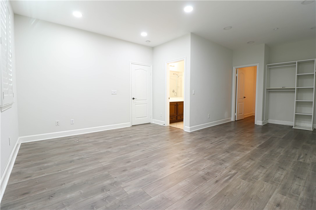 2850 North Stone Pine Glen Santa Ana, CA 92706 - Photo 36 of 45 an empty room with wooden floor and closet