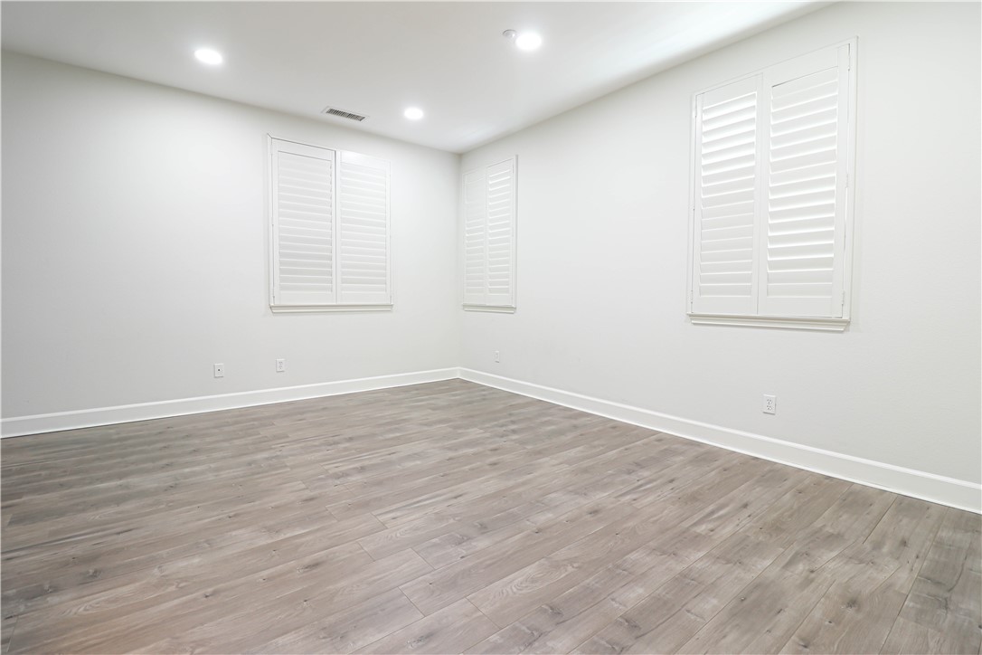 2850 North Stone Pine Glen Santa Ana, CA 92706 - Photo 38 of 45 an empty room with wooden floor and windows