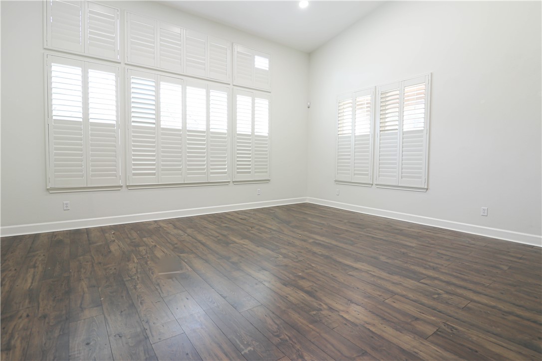 2850 North Stone Pine Glen Santa Ana, CA 92706 - Photo 40 of 45 an empty room with wooden floor and windows