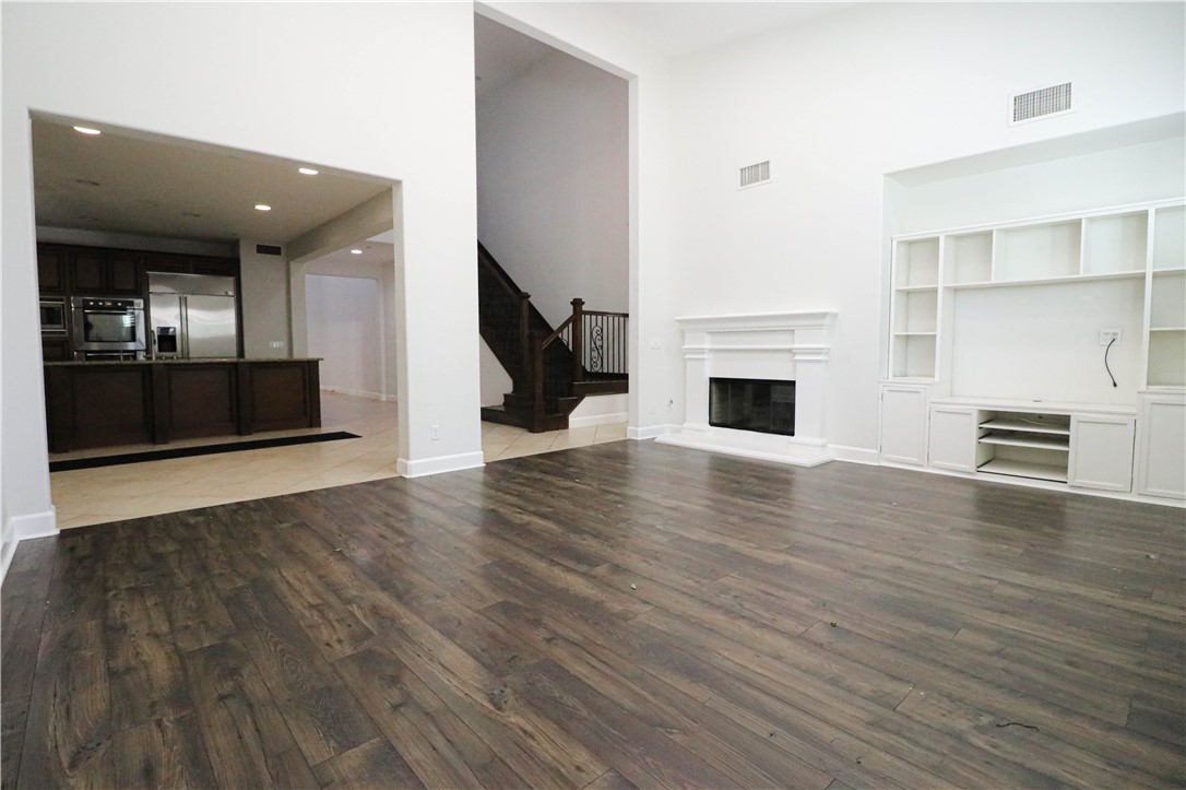 2850 North Stone Pine Glen Santa Ana, CA 92706 - Photo 43 of 45 an empty room with wooden floor fireplace and windows
