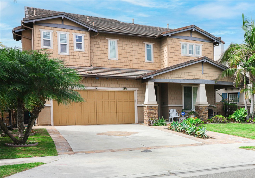 2850 North Stone Pine Glen Santa Ana, CA 92706 - Photo 6 of 45 a front view of a house with a yard and garage
