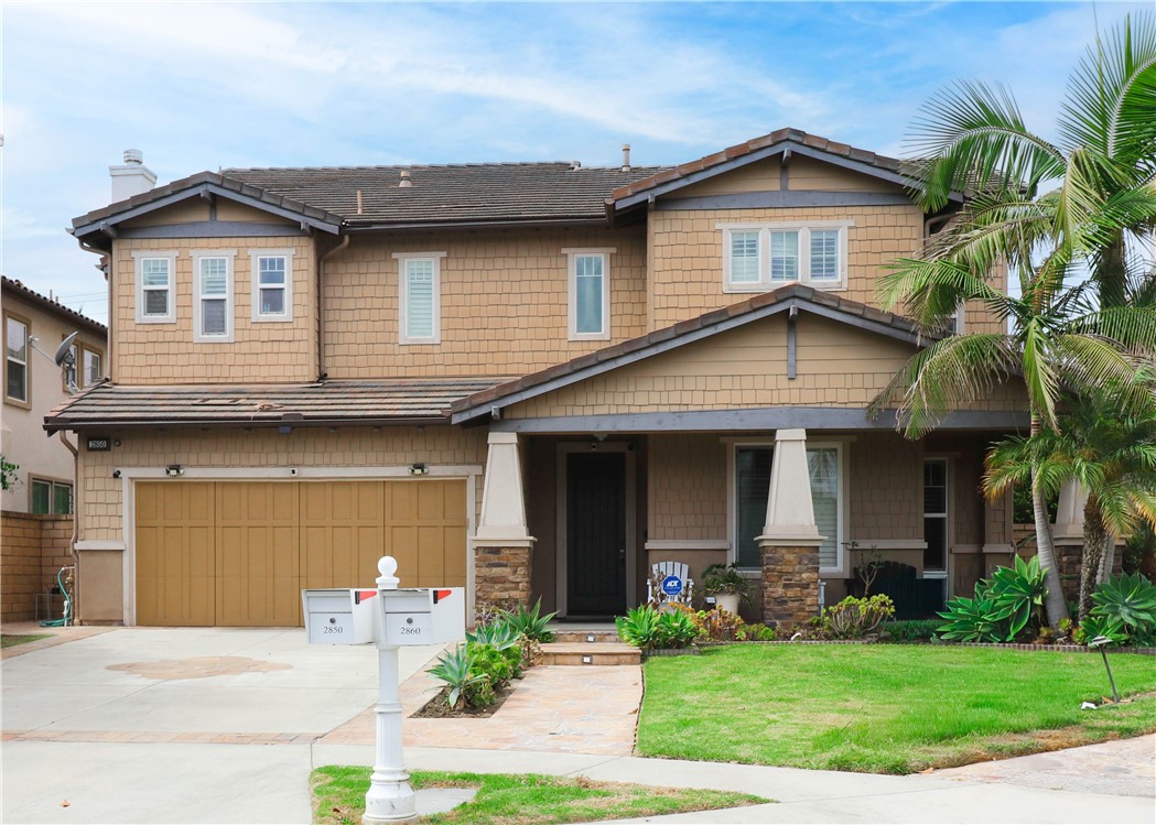 2850 North Stone Pine Glen Santa Ana, CA 92706 - Photo 7 of 45 a front view of a house with a yard and potted plants