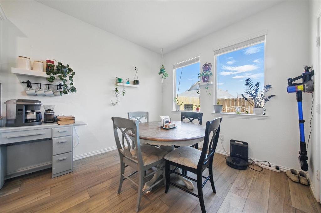 14808 Hester Trail Fort Worth, TX 76052 - Photo 7 of 31 a view of a dining room with furniture and wooden floor