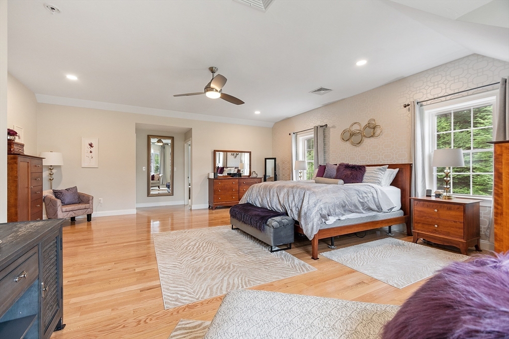 5 Azalea Lane Upton, MA 01568 - Photo 19 of 42 a bedroom with a large bed and a chandelier