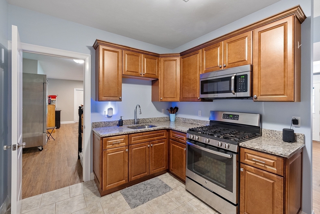 5 Azalea Lane Upton, MA 01568 - Photo 30 of 42 a kitchen with stainless steel appliances granite countertop wooden cabinets stove a sink and a window