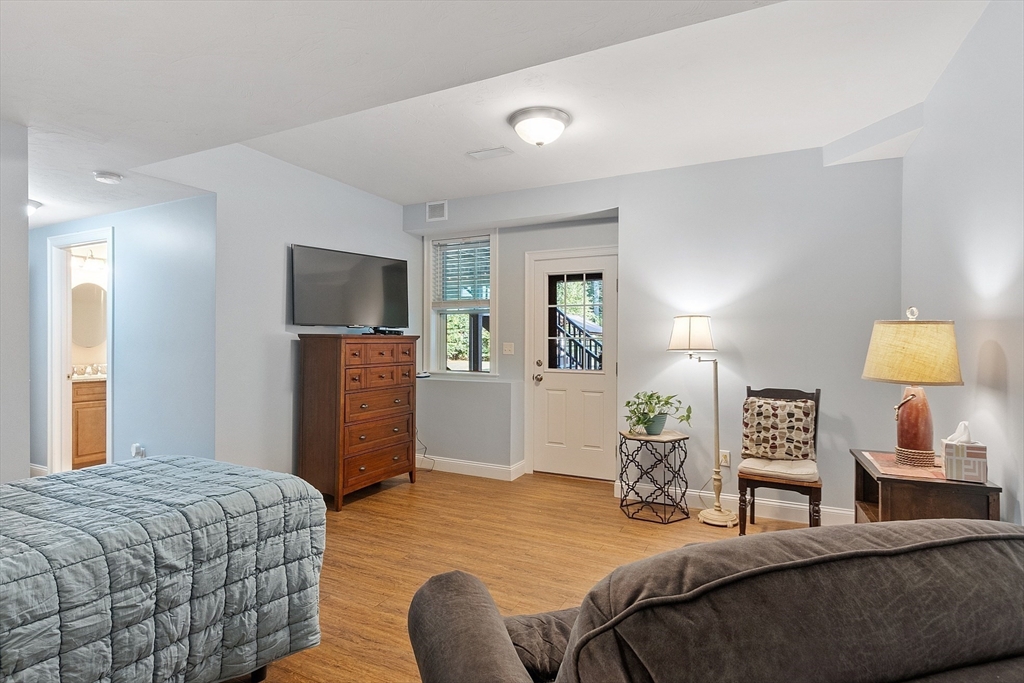 5 Azalea Lane Upton, MA 01568 - Photo 31 of 42 a bedroom with a bed and wooden floor