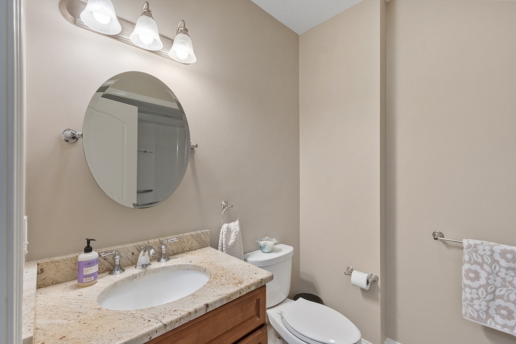 5 Azalea Lane Upton, MA 01568 - Photo 32 of 42 a bathroom with a granite countertop toilet a sink and a mirror