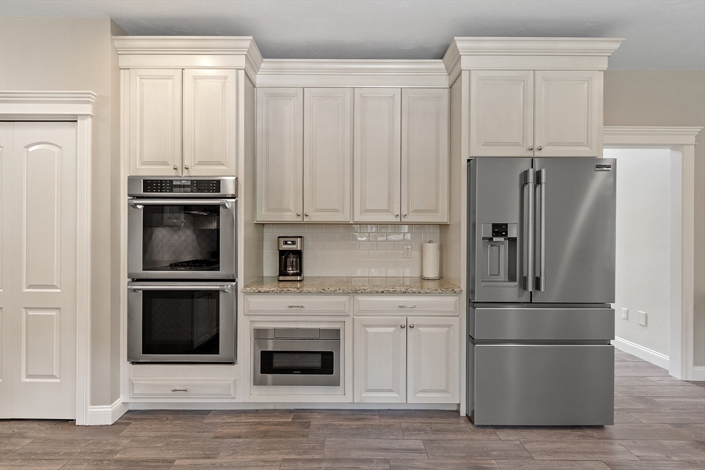 5 Azalea Lane Upton, MA 01568 - Photo 8 of 42 a kitchen with granite countertop a refrigerator stove and cabinets