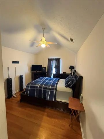 a bedroom with furniture and a mirror