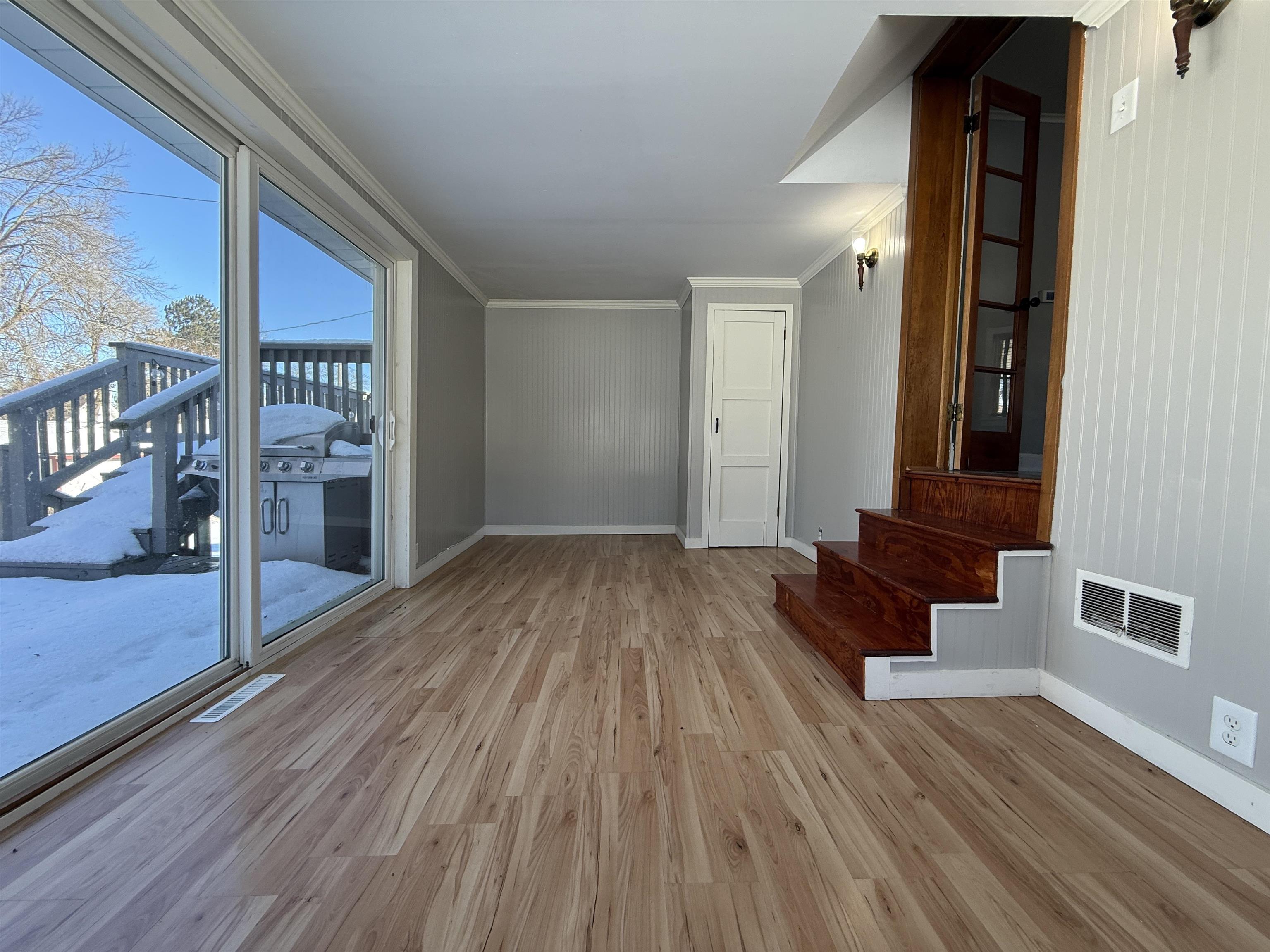 126 5th Street Northwest Chisholm, MN 55719 - Photo 17 of 35 Unfurnished living room featuring light wood-type flooring and ornamental molding