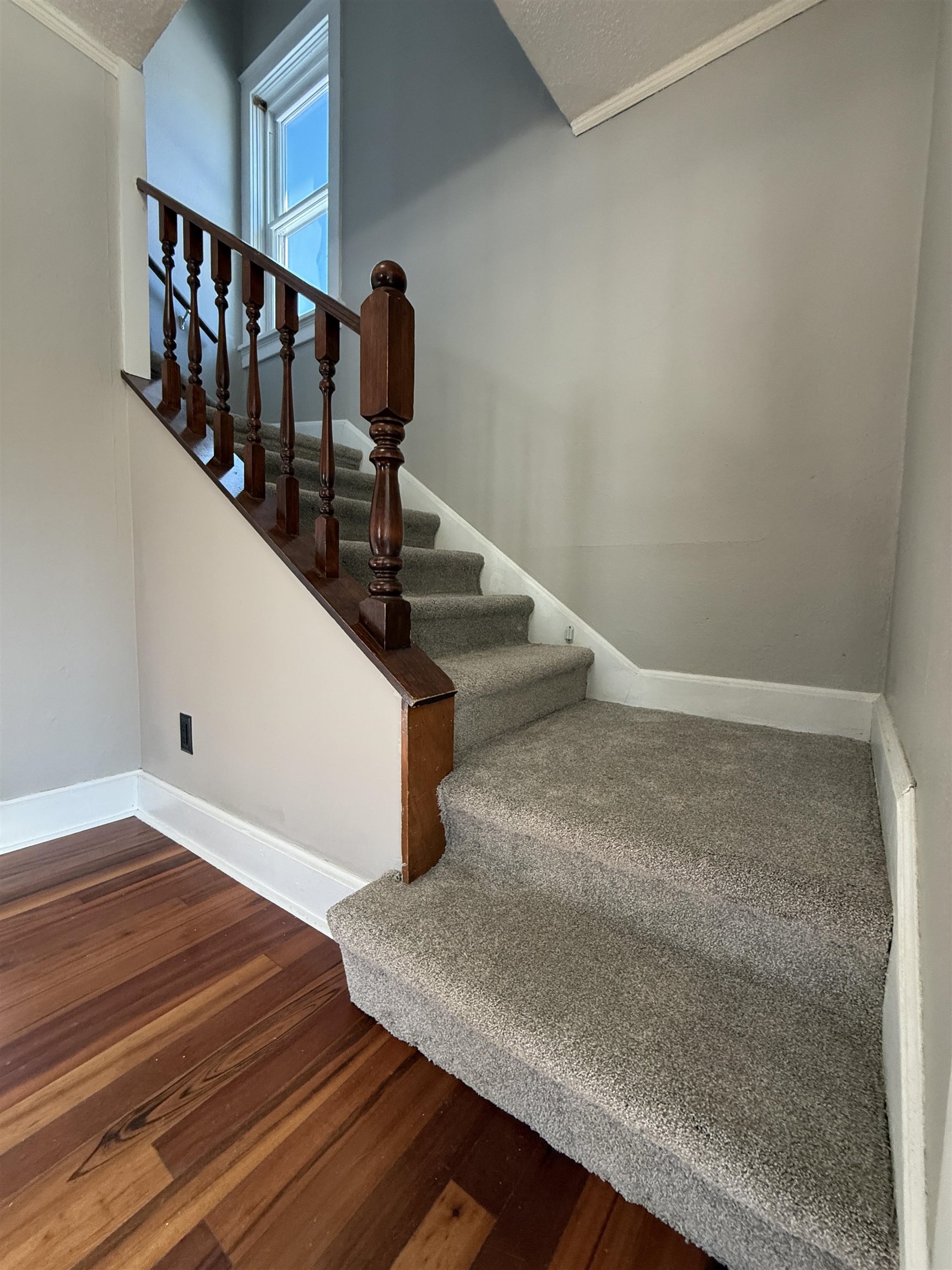 126 5th Street Northwest Chisholm, MN 55719 - Photo 20 of 35 Staircase with wood finished floors, a textured ceiling, and ornamental molding