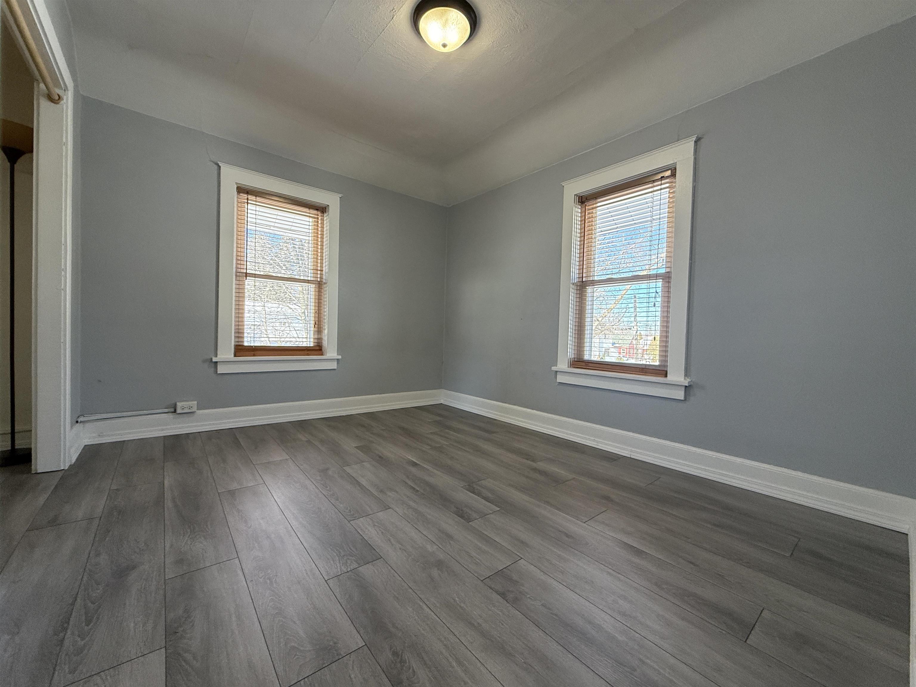 126 5th Street Northwest Chisholm, MN 55719 - Photo 21 of 35 Unfurnished room with dark wood-style floors and healthy amount of natural light