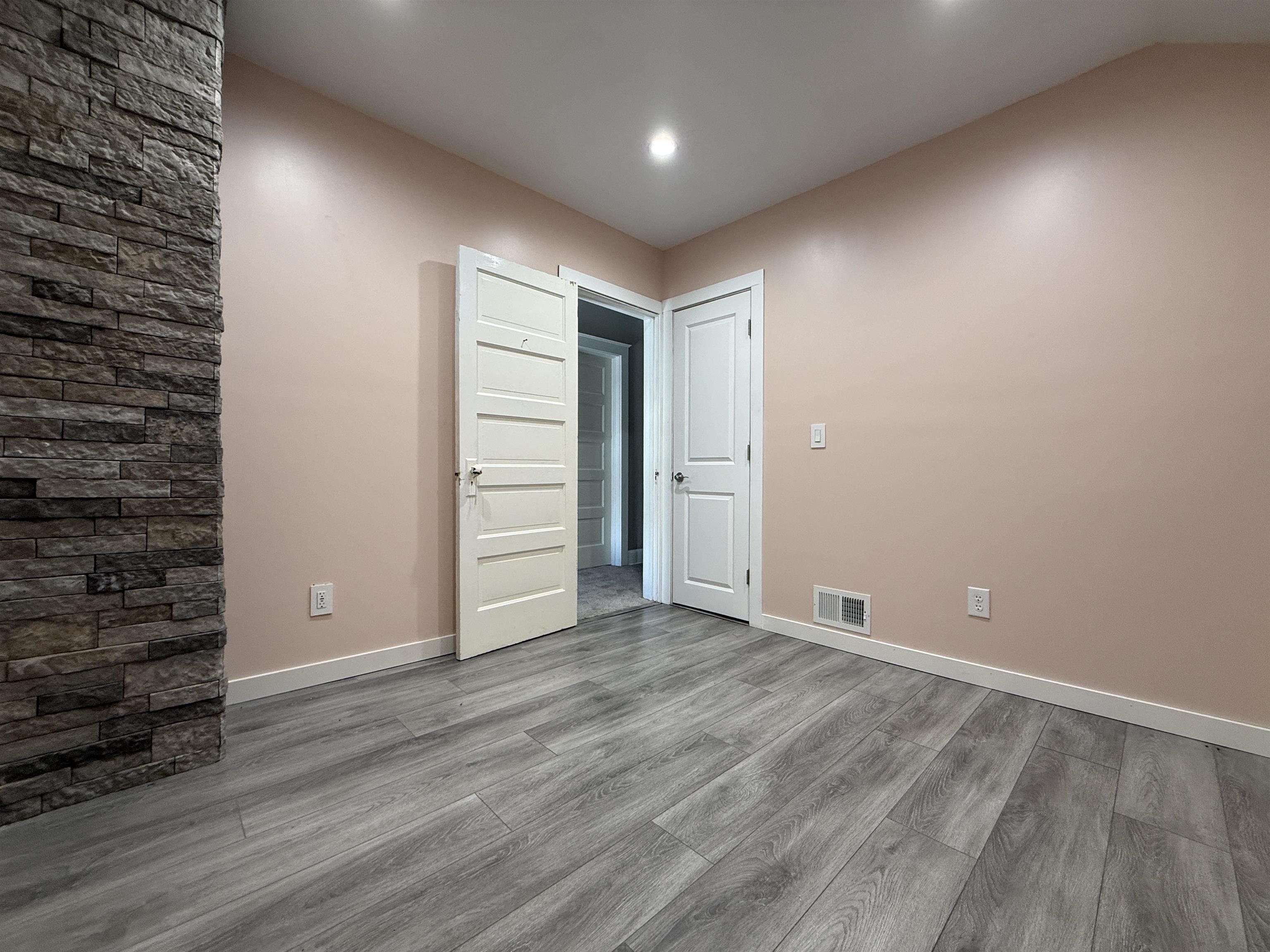 126 5th Street Northwest Chisholm, MN 55719 - Photo 24 of 35 Unfurnished bedroom featuring wood finished floors and recessed lighting