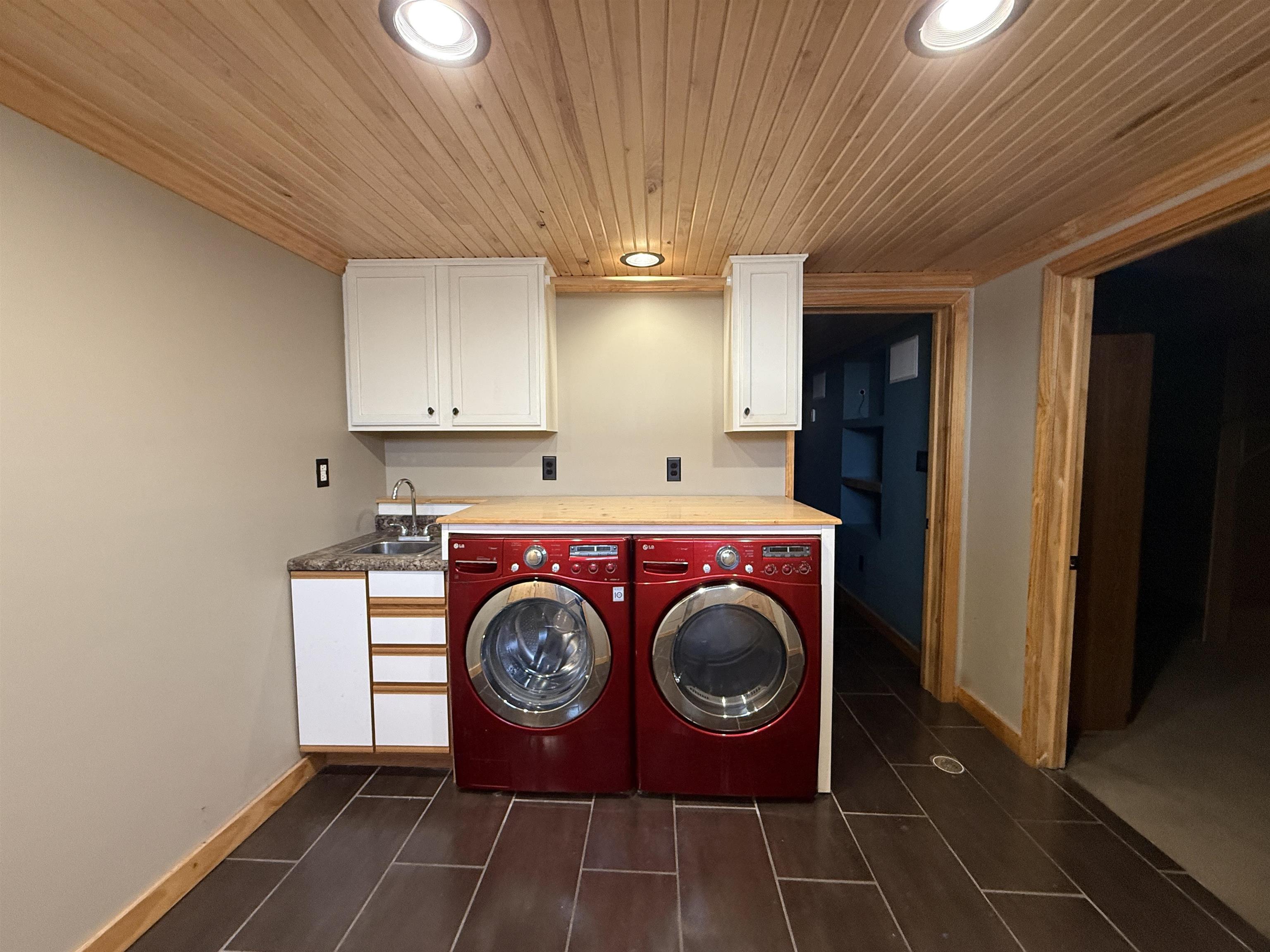 126 5th Street Northwest Chisholm, MN 55719 - Photo 29 of 35 Washroom with wood ceiling, recessed lighting, washer and dryer, and cabinet space