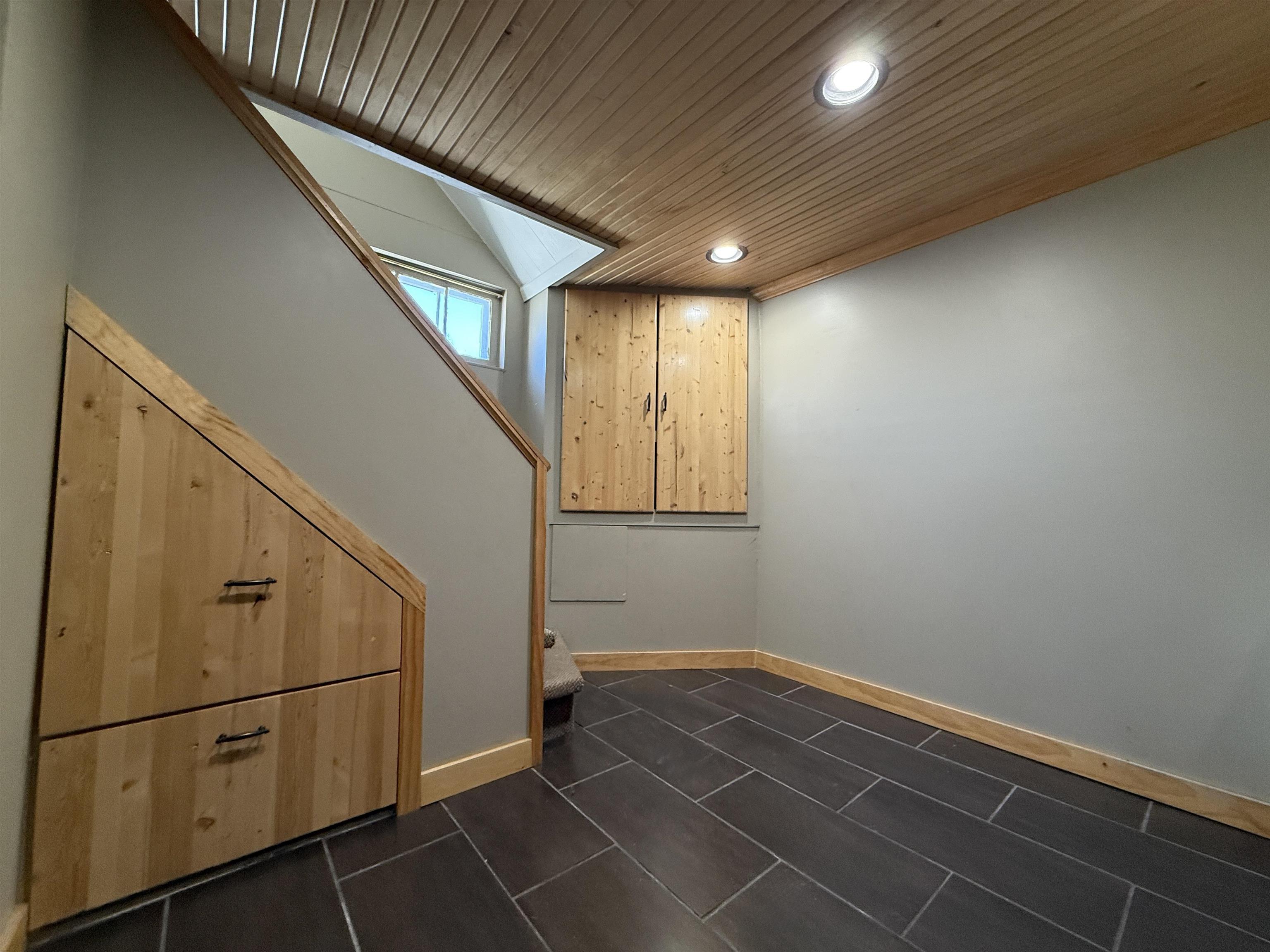 126 5th Street Northwest Chisholm, MN 55719 - Photo 30 of 35 Basement featuring wood ceiling, recessed lighting, stairs, and dark tile patterned floors