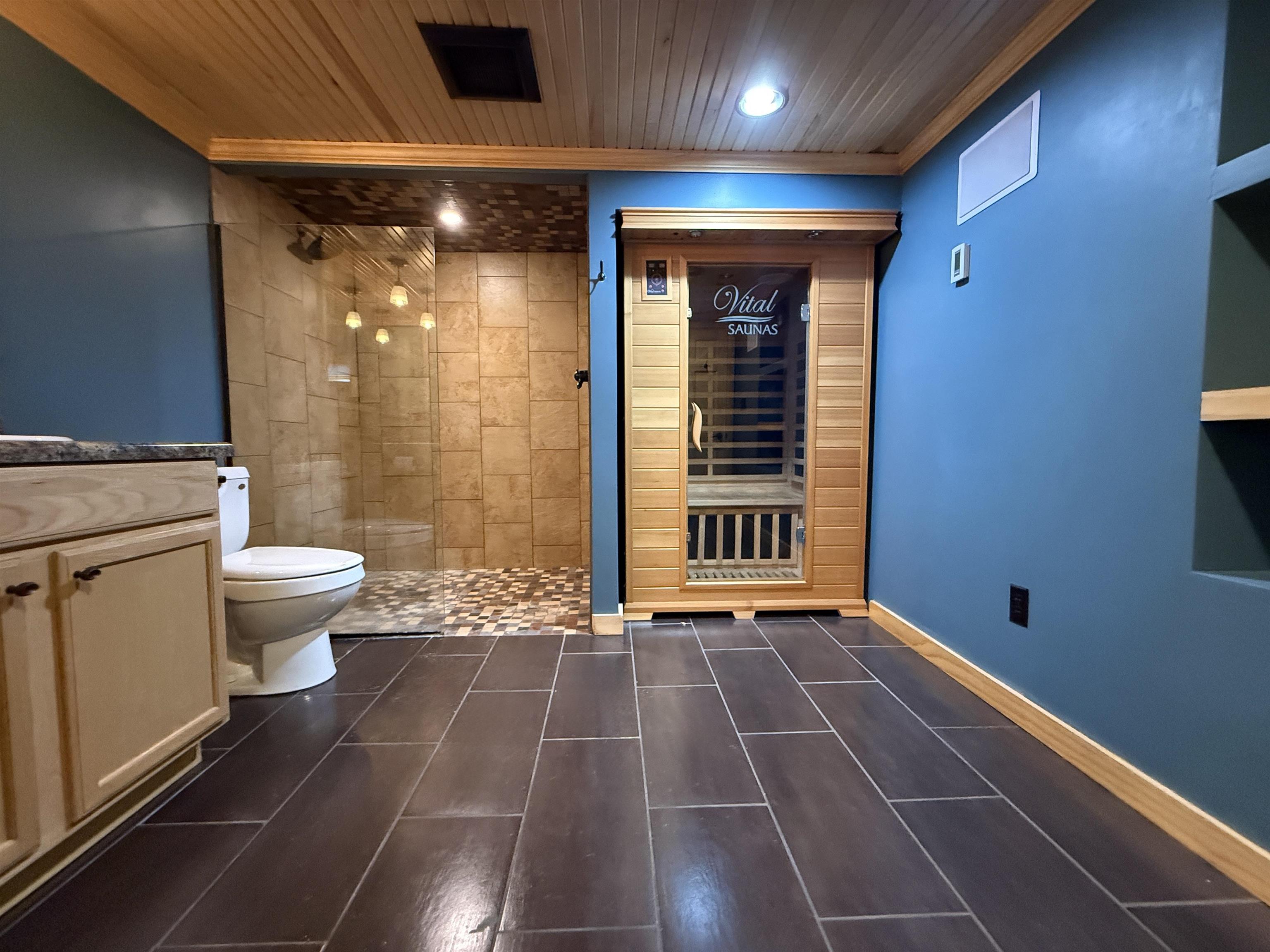 126 5th Street Northwest Chisholm, MN 55719 - Photo 33 of 35 Bathroom with a sauna, wood ceiling, vanity, a shower stall, and crown molding
