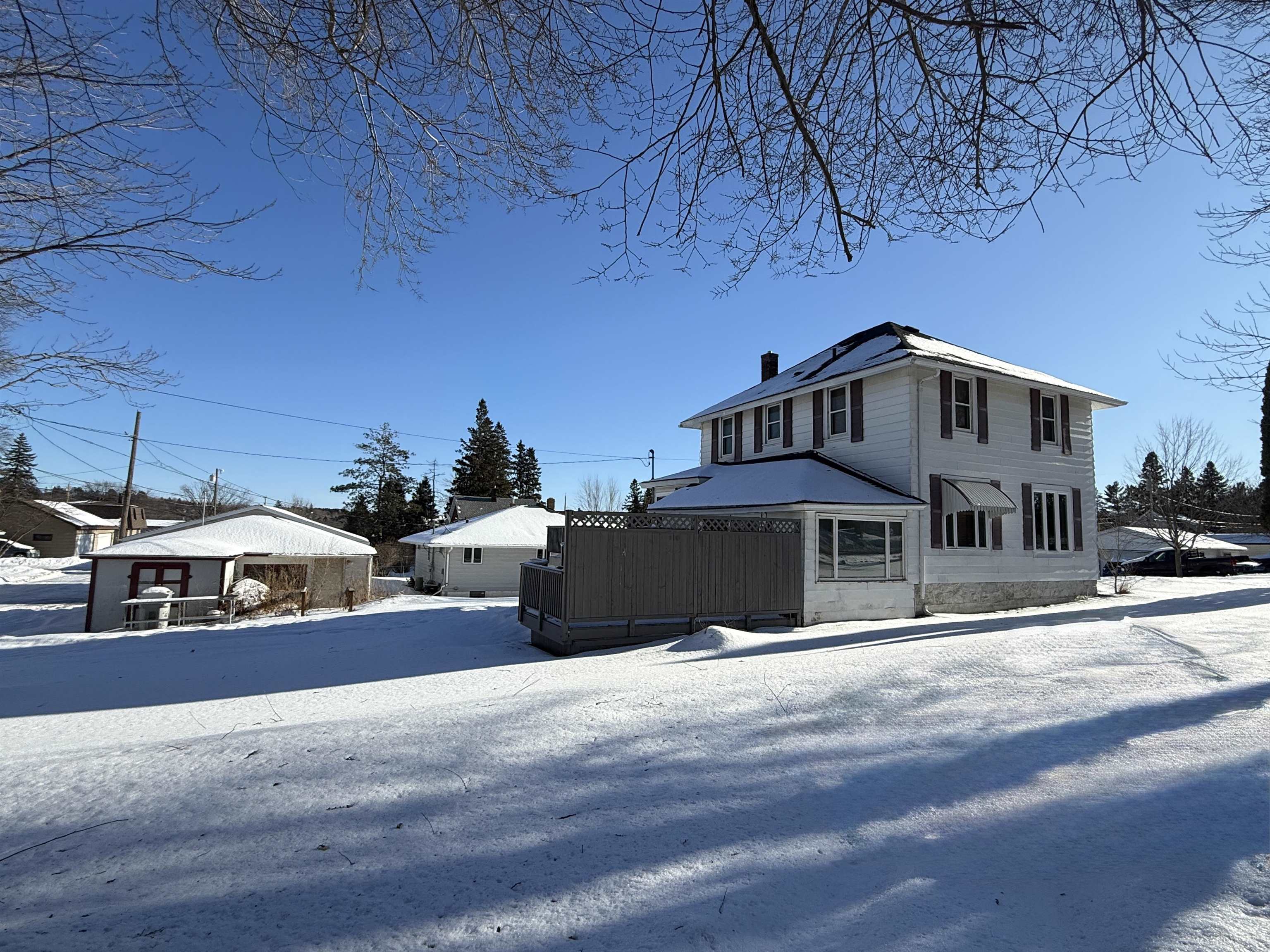 126 5th Street Northwest Chisholm, MN 55719 - Photo 5 of 35 View of front of property with a wooden deck and a chimney