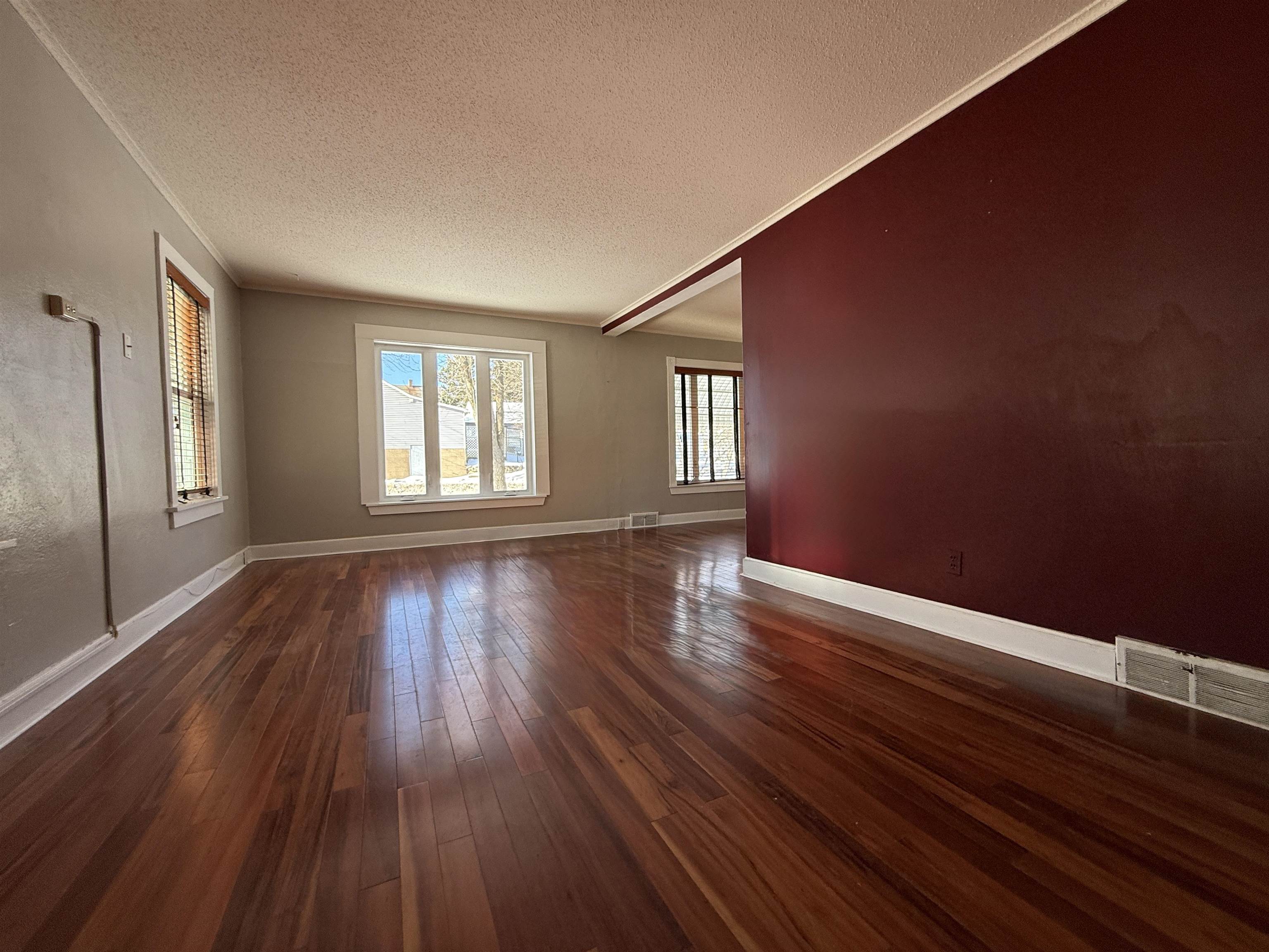 126 5th Street Northwest Chisholm, MN 55719 - Photo 7 of 35 Spare room featuring a textured ceiling and dark wood-style floors