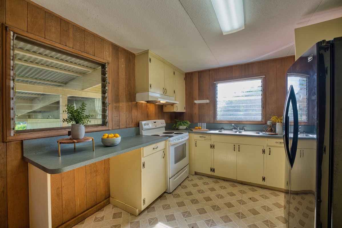 235 Malaai Road Hilo, HI 96720 - Photo 5 of 14 a kitchen with stainless steel appliances granite countertop a sink stove and refrigerator