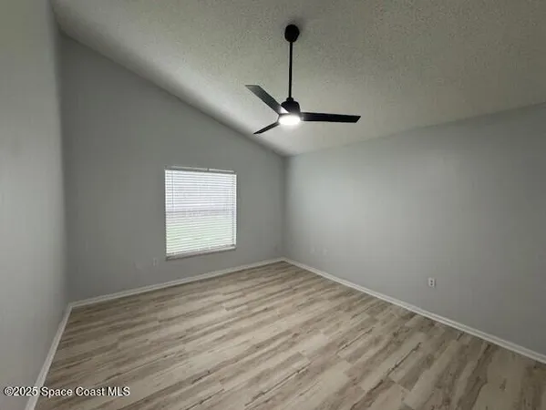 a view of room with window and ceiling fan