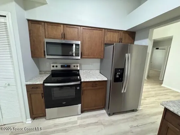 a kitchen with a stove microwave and refrigerator