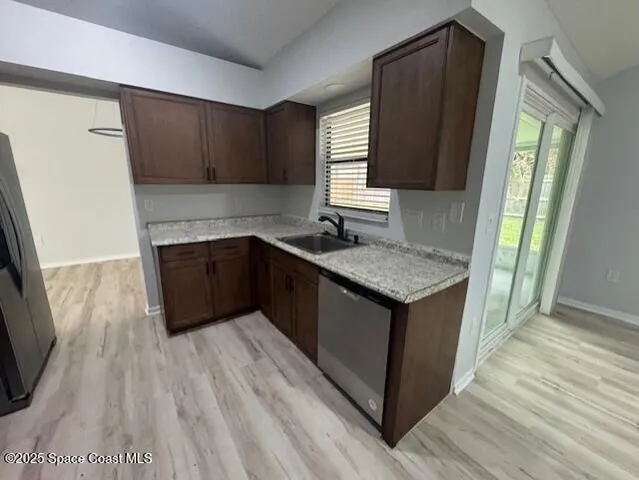 a kitchen with granite countertop a sink stove and cabinets