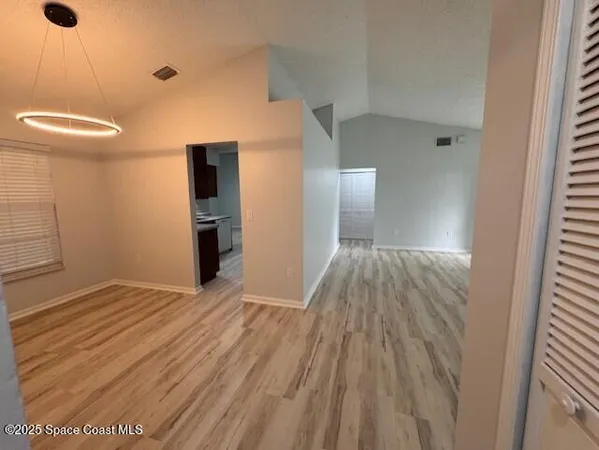 a view of a room with wooden floor