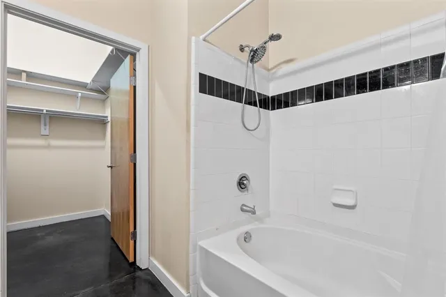 a bathroom with a bathtub and shower