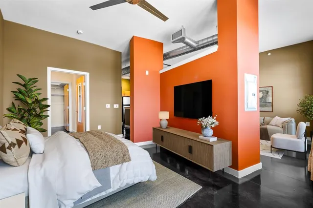 a bedroom with a bed and flat screen tv