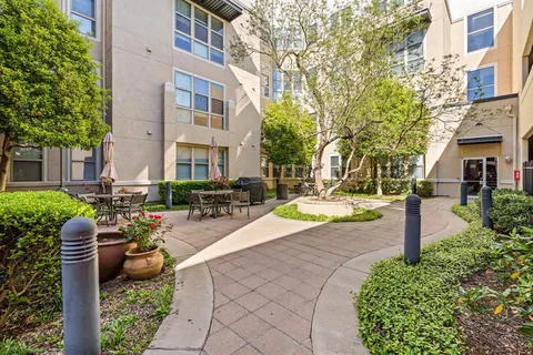 a dining hall with lots of tables and chairs