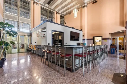 a room with pool table and chairs