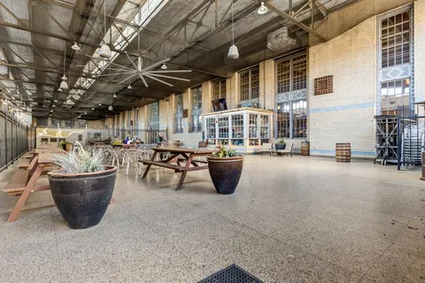 a lobby with furniture and potted plants