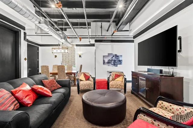 a view of a water heater room with wooden floor