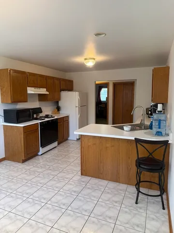 a kitchen with stainless steel appliances a sink and a refrigerator