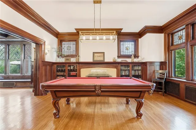 a room with pool table and windows