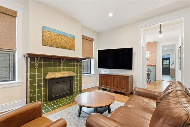 a living room with furniture a flat screen tv and a fireplace