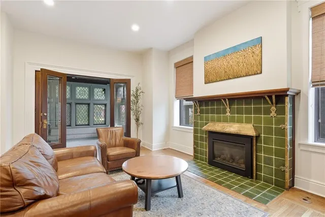 a living room with furniture a flat screen tv and a fireplace