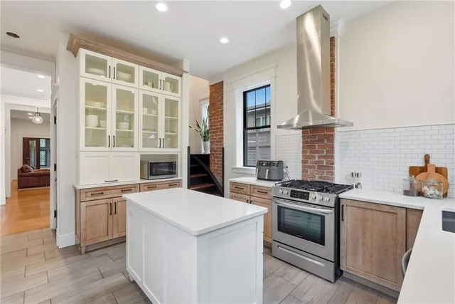a kitchen with white cabinets and appliances