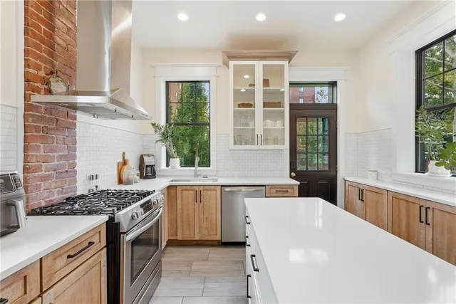 a kitchen with a sink stove and cabinets
