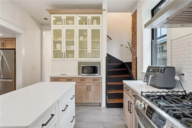 a kitchen with a stove top oven and sink