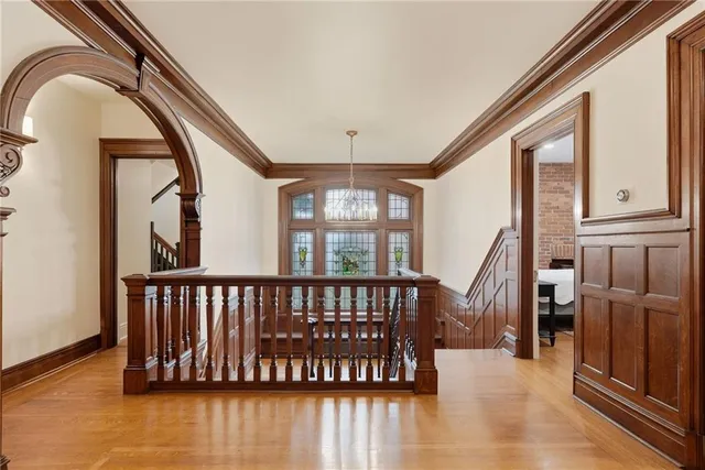a view of hallway with stairs and wooden floor
