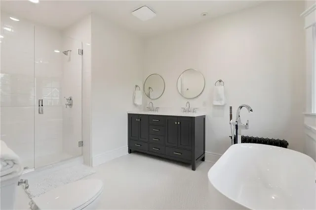 a bathroom with a toilet a sink and shower