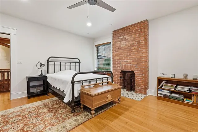 a spacious bedroom with a bed and a fireplace